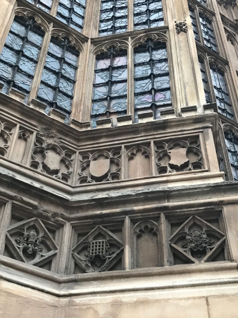 Architectural detail on Westminster Abbey. Note the crests: the waffle looking bit is really a portcullis, which represents Lady Margaret Beaufort - Henry VIII's paternal grandmother; the flower on the right is the Tudor rose. London, Dec. 2016.
